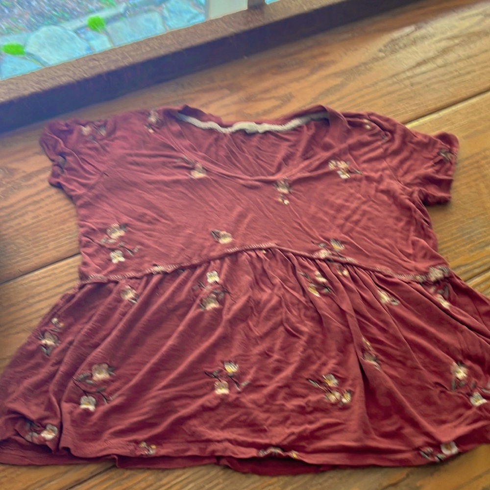 Rewind top that is flowy and has yellow flowers and the main color is maroon